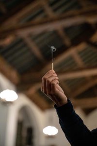 211106_MariaJoseWSGroup1_017 A hand holds up a match as it sparks out and releases a puff of smoke.