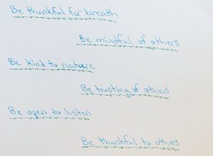 Blue text with green lines beneath it reads: Be thankful for breath. Be mindful of others. Be kind to nature. Be trusting of others. Be open to listen. Be thankful to others.