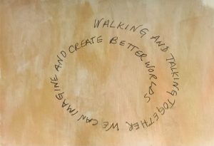 Black text forming a spiral against a golden background. The text reads: WALKING AND TALKING TOGETHER WE CAN IMAGINE AND CREATE BETTER WORLDS