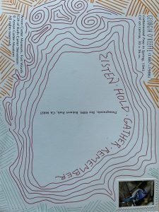 Blue postcard with red, blue, and orange line drawings. In the center, the postcard says LISTEN HOLD GATHER REMEMBER. In one corner, a stamp features a blue bird. In two other corners, text explains that this postcard is from the Amon Carter Museum in Fort Worth and features a painting by Georgie O'Keefe entitled Cottonwood Tree in Spring on the reverse side.